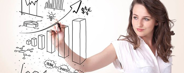 Young business woman drawing various diagrams on whiteboard