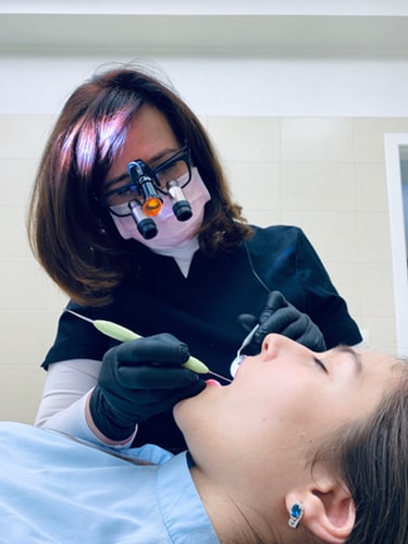 Dentista examinando una caries con material odontológico